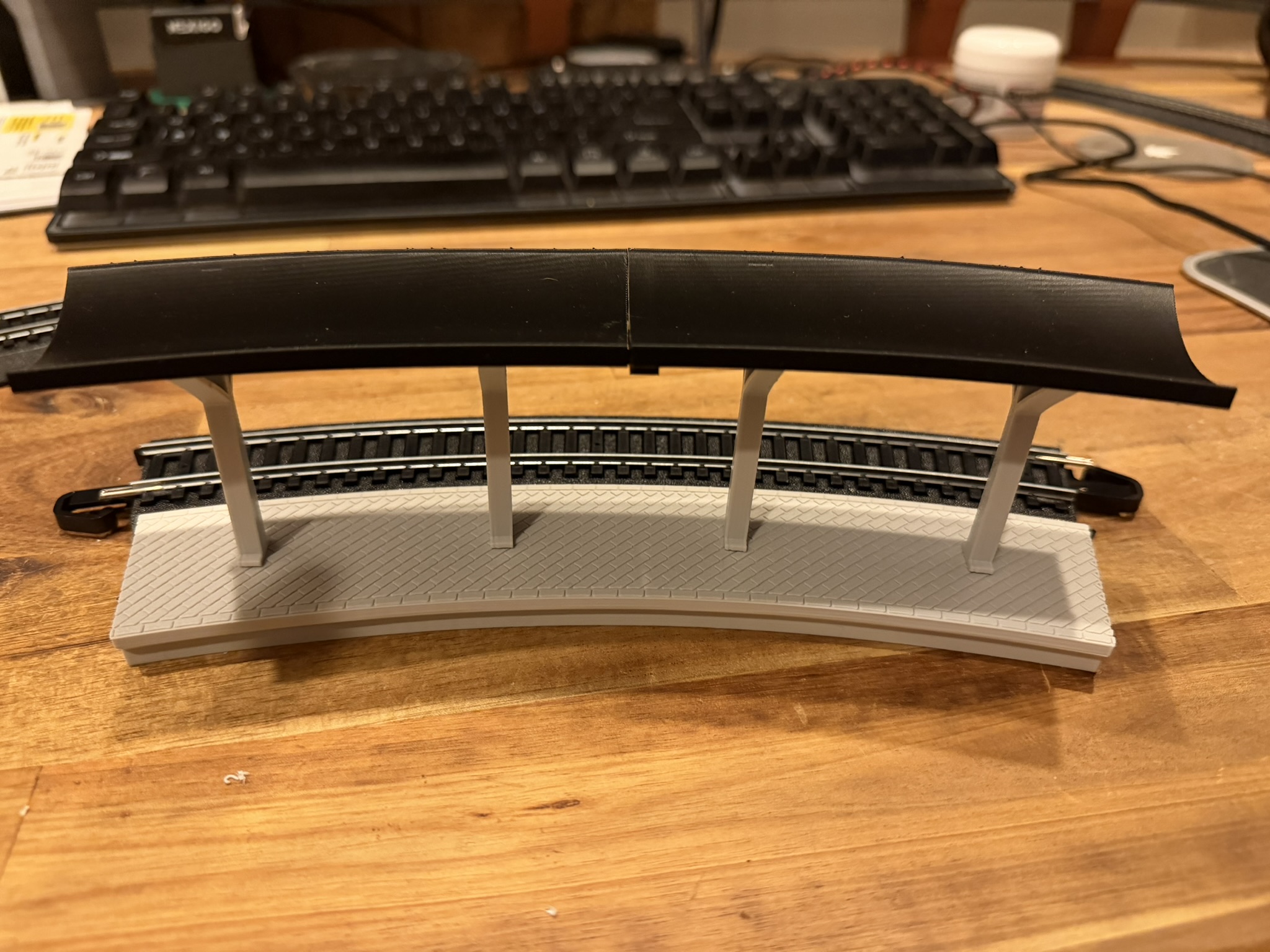 Real print: assembled curved station beside a Bachmann E-Z Track 18 in curve