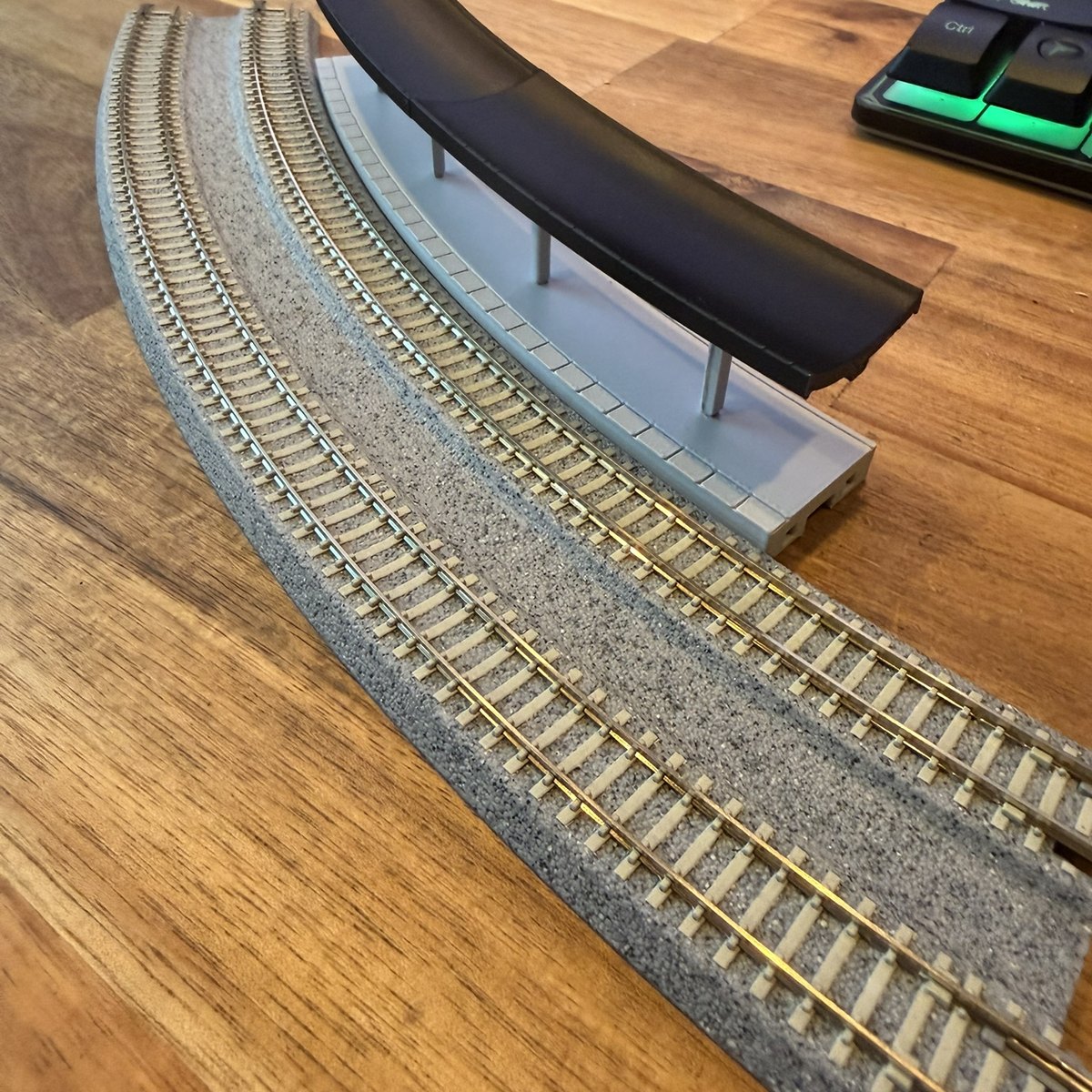 Real print: the curved station seen along the Kato Unitrack curve, canopy over the platform